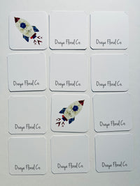 Set of Oxeye Floral Co. branded cards with floral designs on a white background