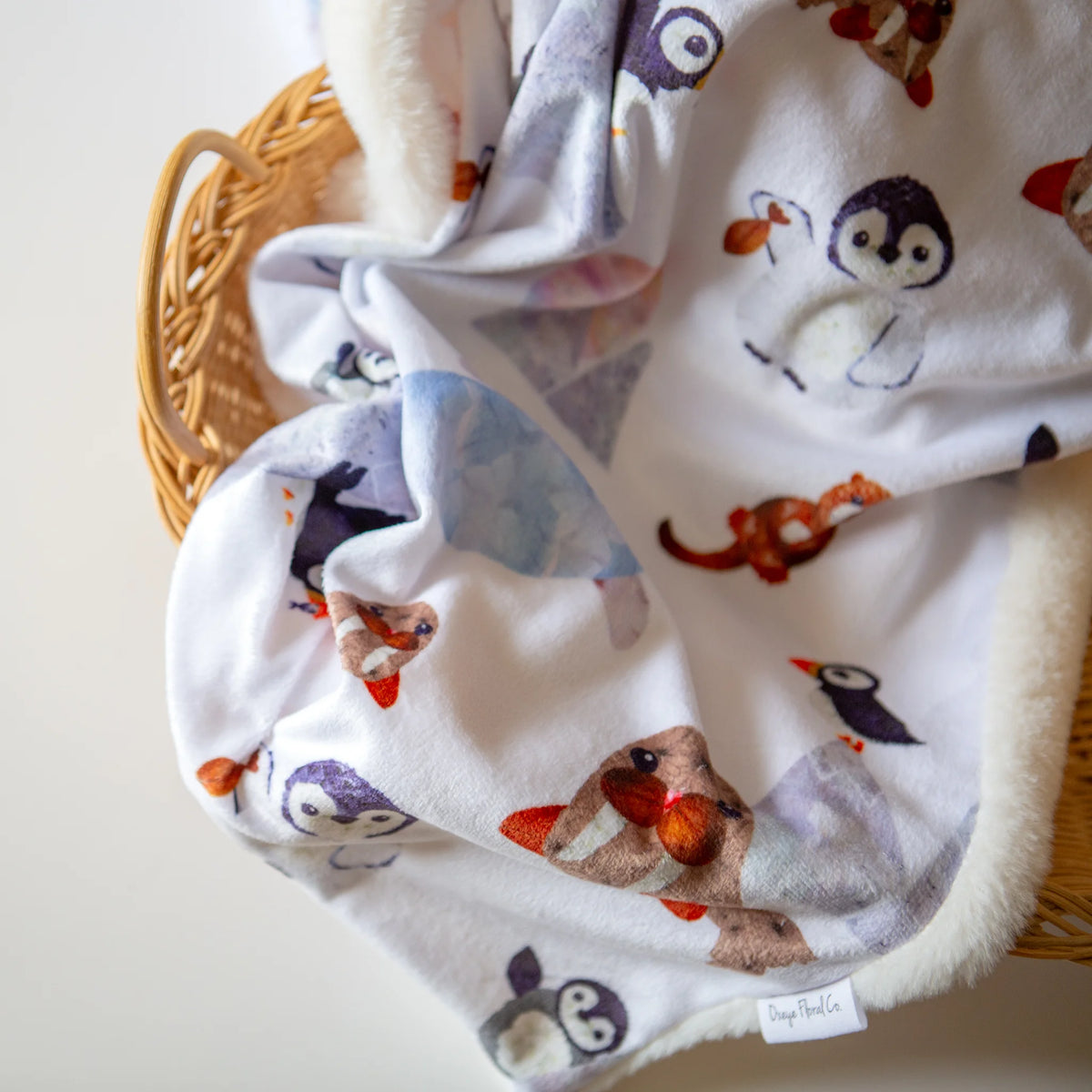Penguins and walruses on a baby blanket