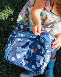 Child opening blue floral Arctic Cuties lunch box by Oxeye Floral Co