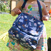 Child holding Arctic Cuties animal pattern lunch bag by Oxeye Floral Co