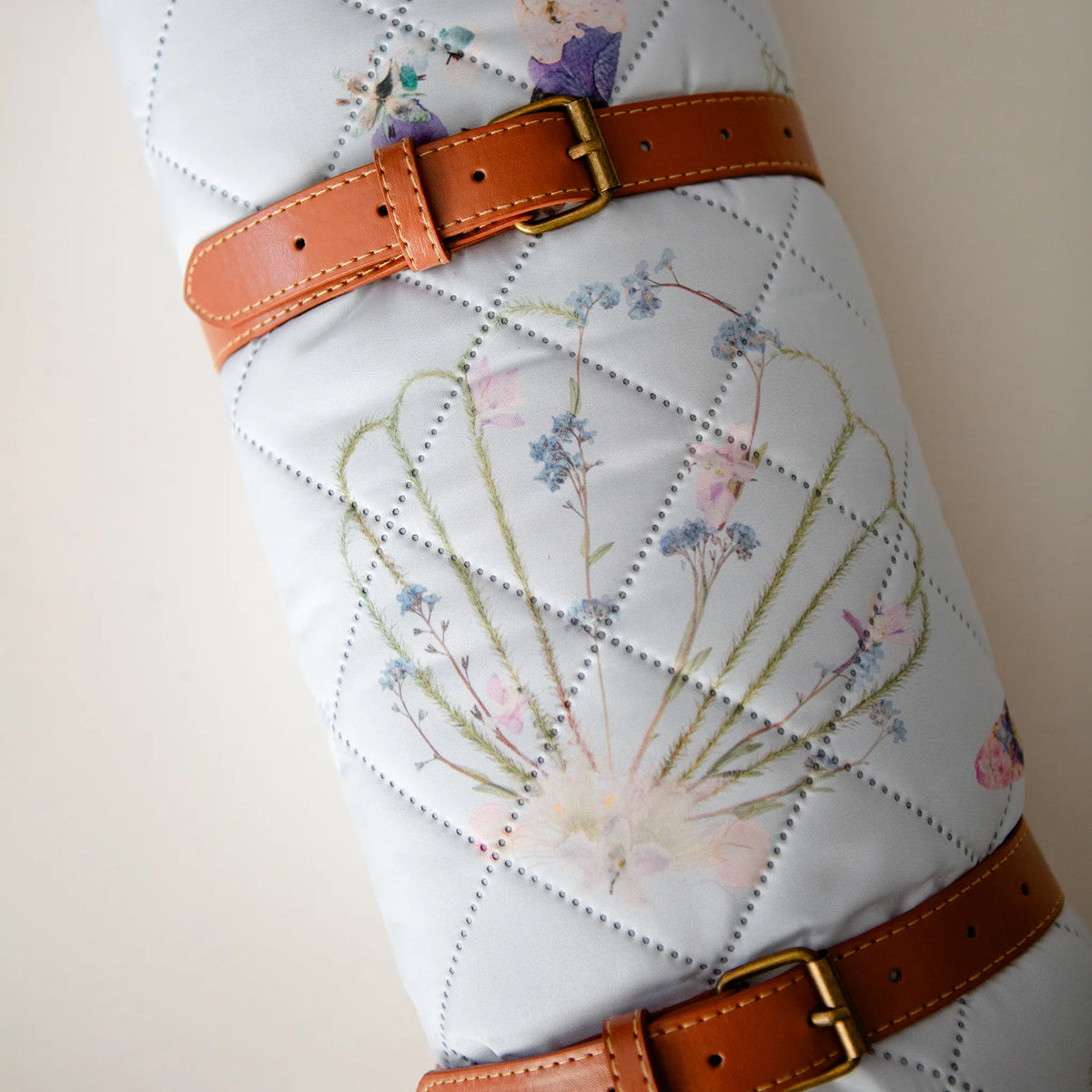 Coastal Drift Voyager Blanket by Oxeye Floral Co, rolled up with faux leather handle