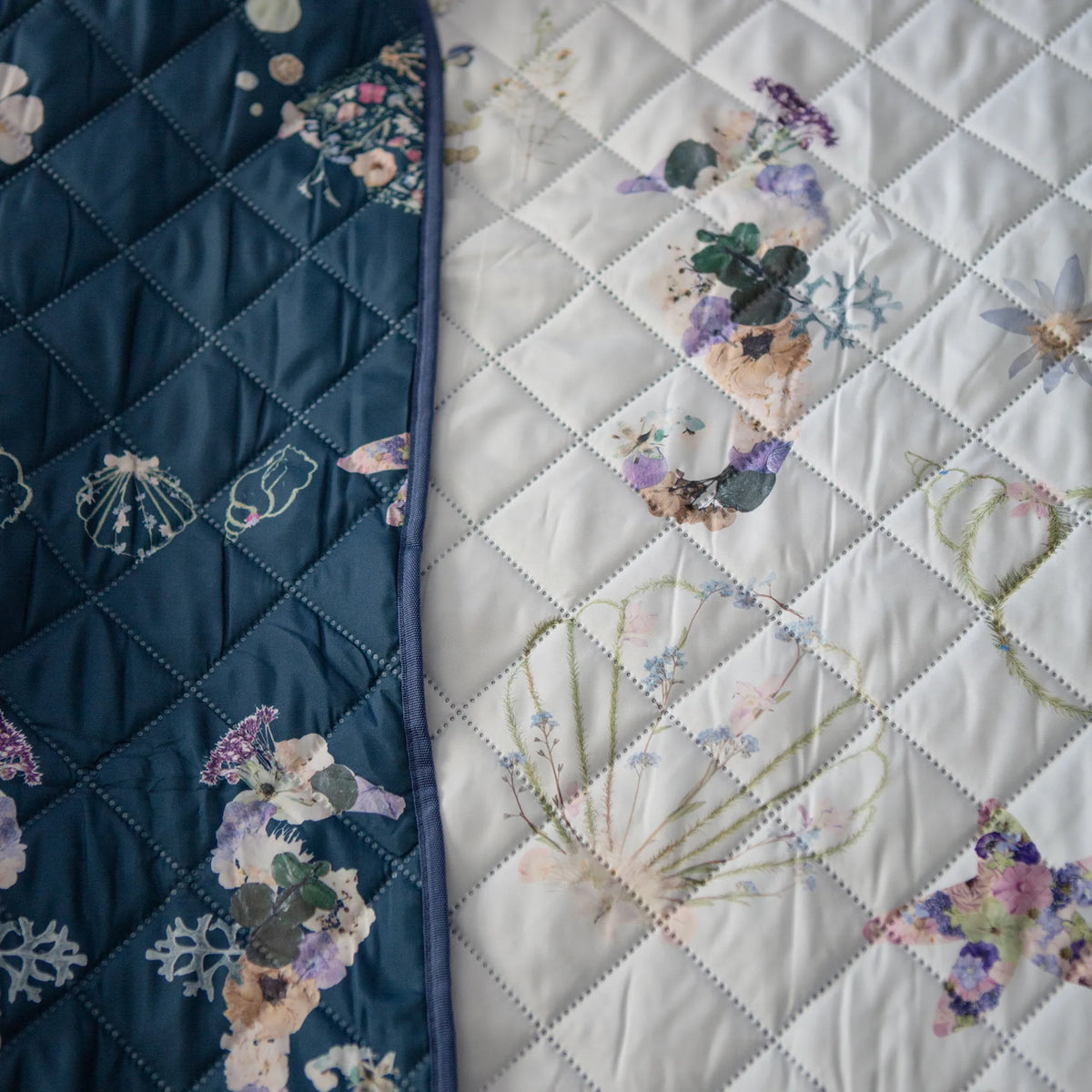 Outdoor blanket with pressed flower sea horses folded over to see both sides