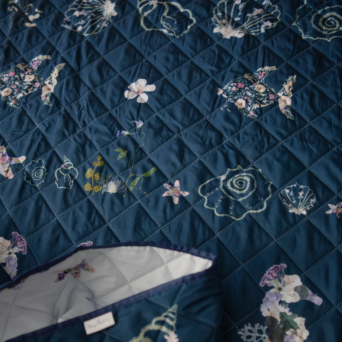 Double sided navy quilt with floral and shell patterns by Oxeye Floral Co