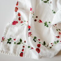 Ladybug Ladder newborn swaddle with pressed flowers