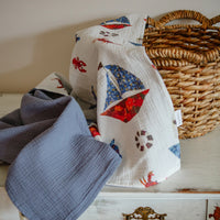 Pressed flower sailboats on a cotton baby blanket