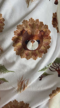 Pressed foliage lion design on a plush baby blanket