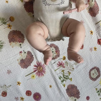 Baby on a hedgehog floral cotton blanket