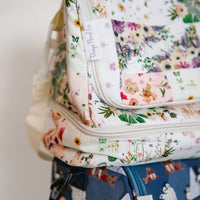Floral-patterned insulated lunch bag with a visible Oxeye Floral Co brand label on a neutral background