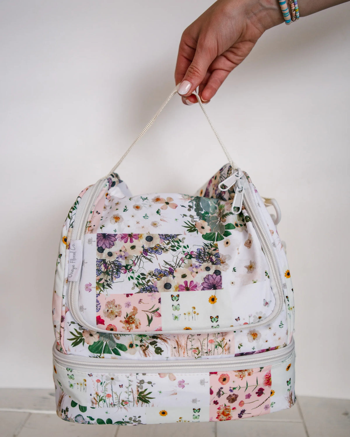 Floral-patterned soft lunch box with pressed flower design by Oxeye Floral Co
