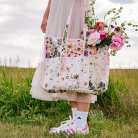 Girl holding Verona quilted tote with flowers