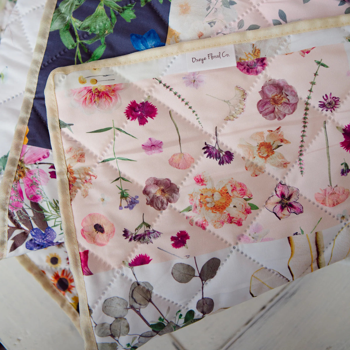 Floral patterned fabric with visible stitching on a white surface