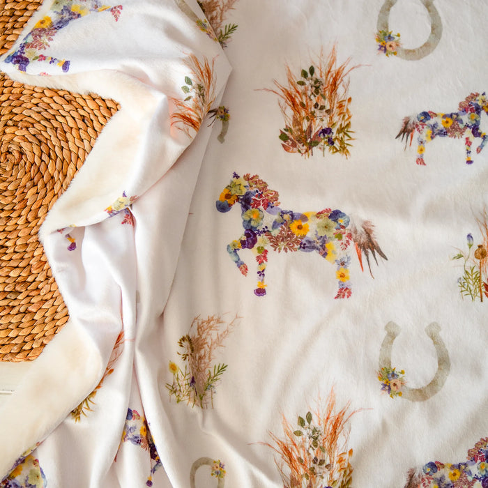 Western-style throw blanket with pressed flower horses