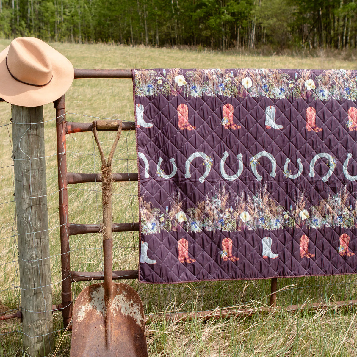 western theme outdoor blanket with pressed flower designs on a farm gate