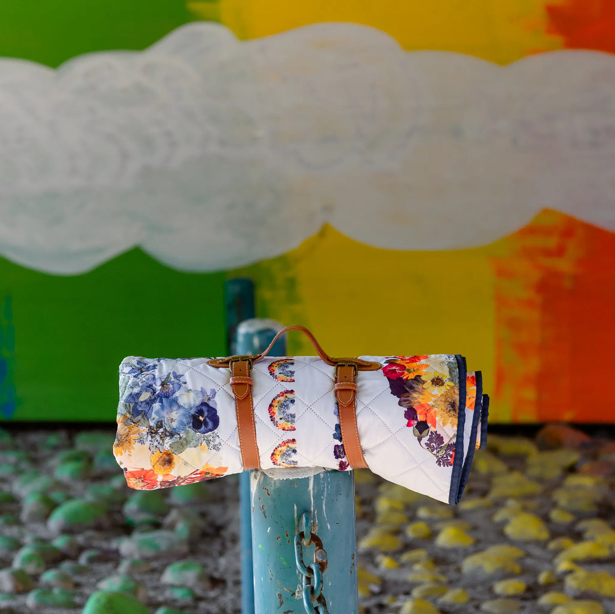 Colorful blanket with floral patterns on a stand against a multicolored background
