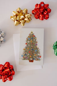 Decorative greeting card with a Christmas tree design surrounded by colorful bows on a white background