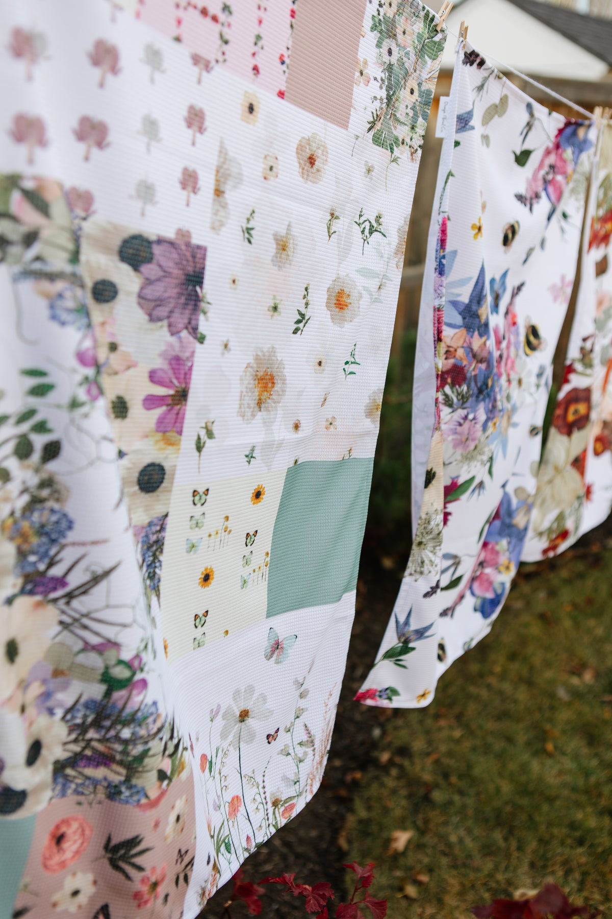 Floral-patterned towels hanging on a line outdoors