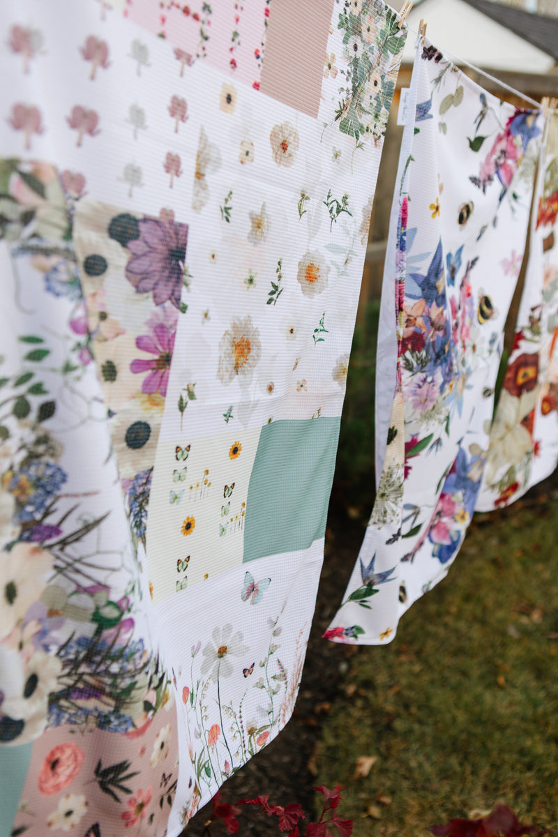 Floral-patterned towels hanging on a line outdoors