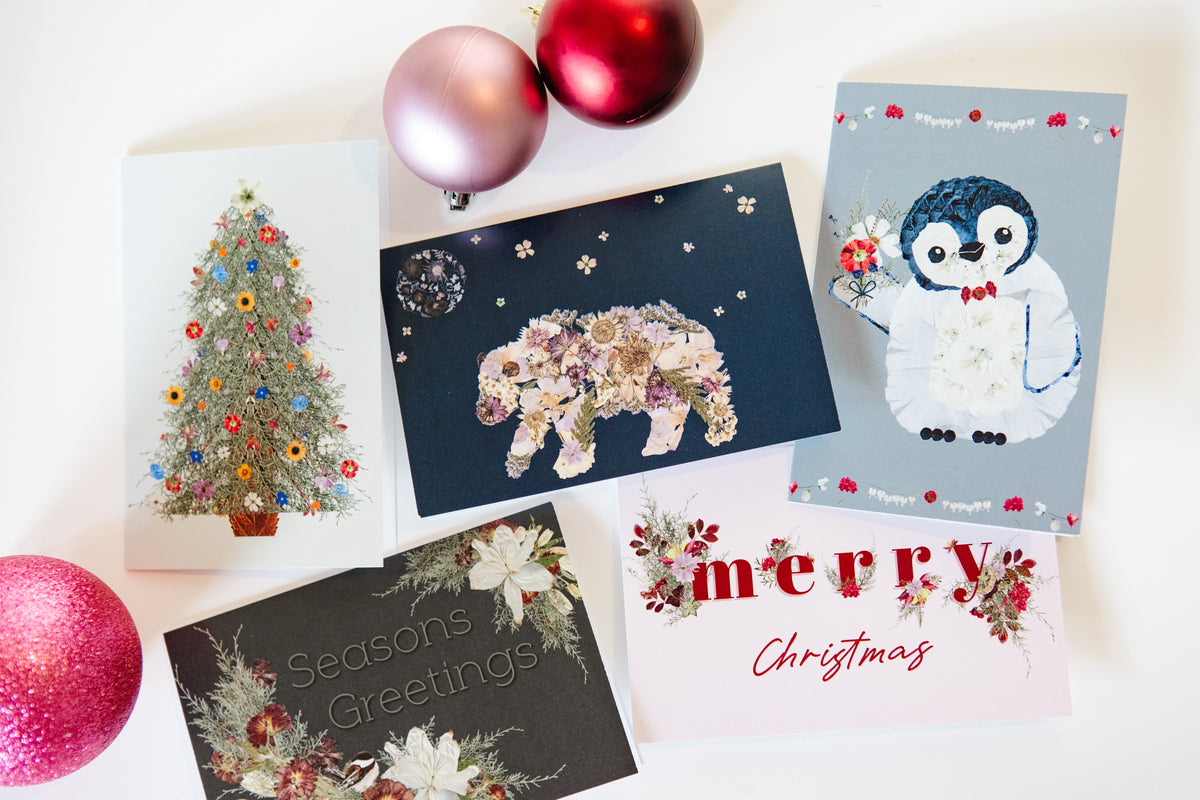 Collection of Christmas-themed greeting cards with decorative elements on a white background.