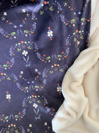 Flowers and butterflies on a beautiful dark satin throw blanket