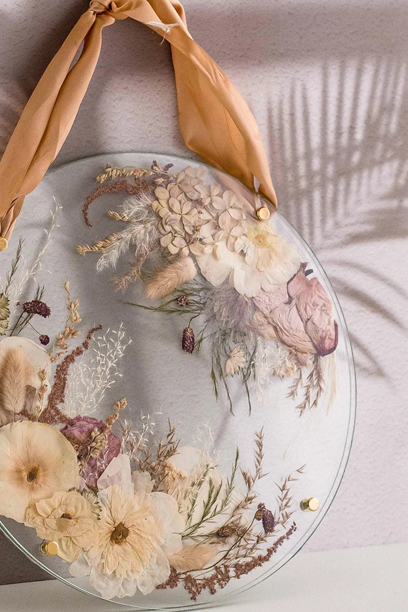 Unique pressed flower art in a circular glass frame