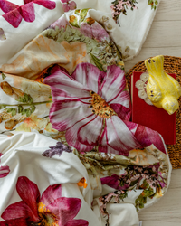 Large pink, white and cream pressed flower blanket with ceramic bird, doilies and book