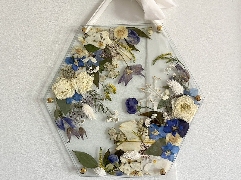 preserved bridal bouquet arranged in a hexagonal glass frame