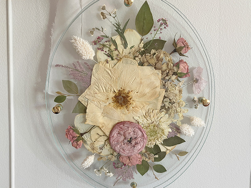 Pressed wedding bouquet in an oval shape glass frame