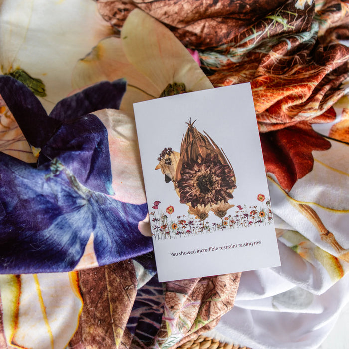 Card with a chicken butt design on a colorful fabric background