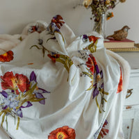 Just for Company pressed flower blanket by Oxeye Floral Co on a dresser with some bird decor and flowers in the background