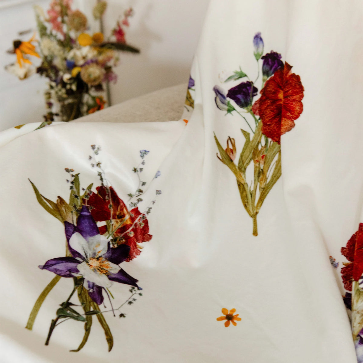 Closeup of a pressed flower design on a white blanket