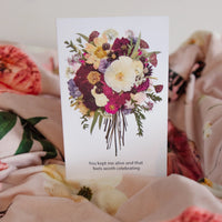Floral card with a bouquet of flowers and text on a floral throw blanket