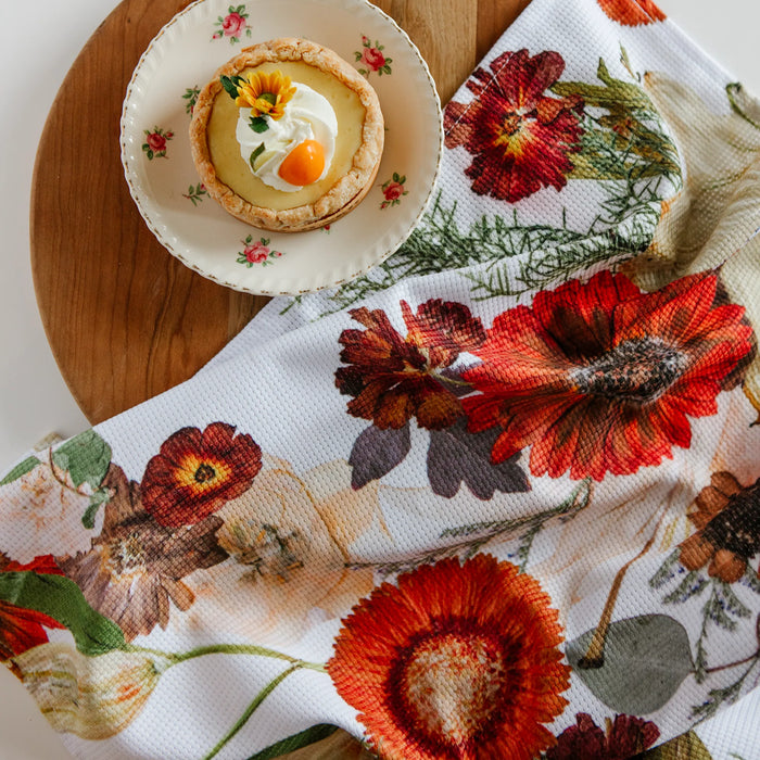 Floral-patterned tea towel with a small dessert on a plate