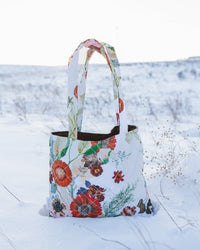 Pressed flower patterned tote with quilted fabric on the snow outside