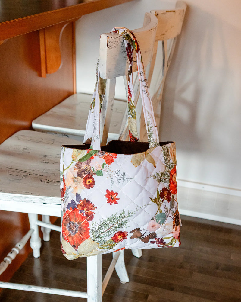 Floral tote bag on a wooden chair indoors