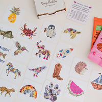 Floral-themed memory game cards with decorative elements on a light surface.