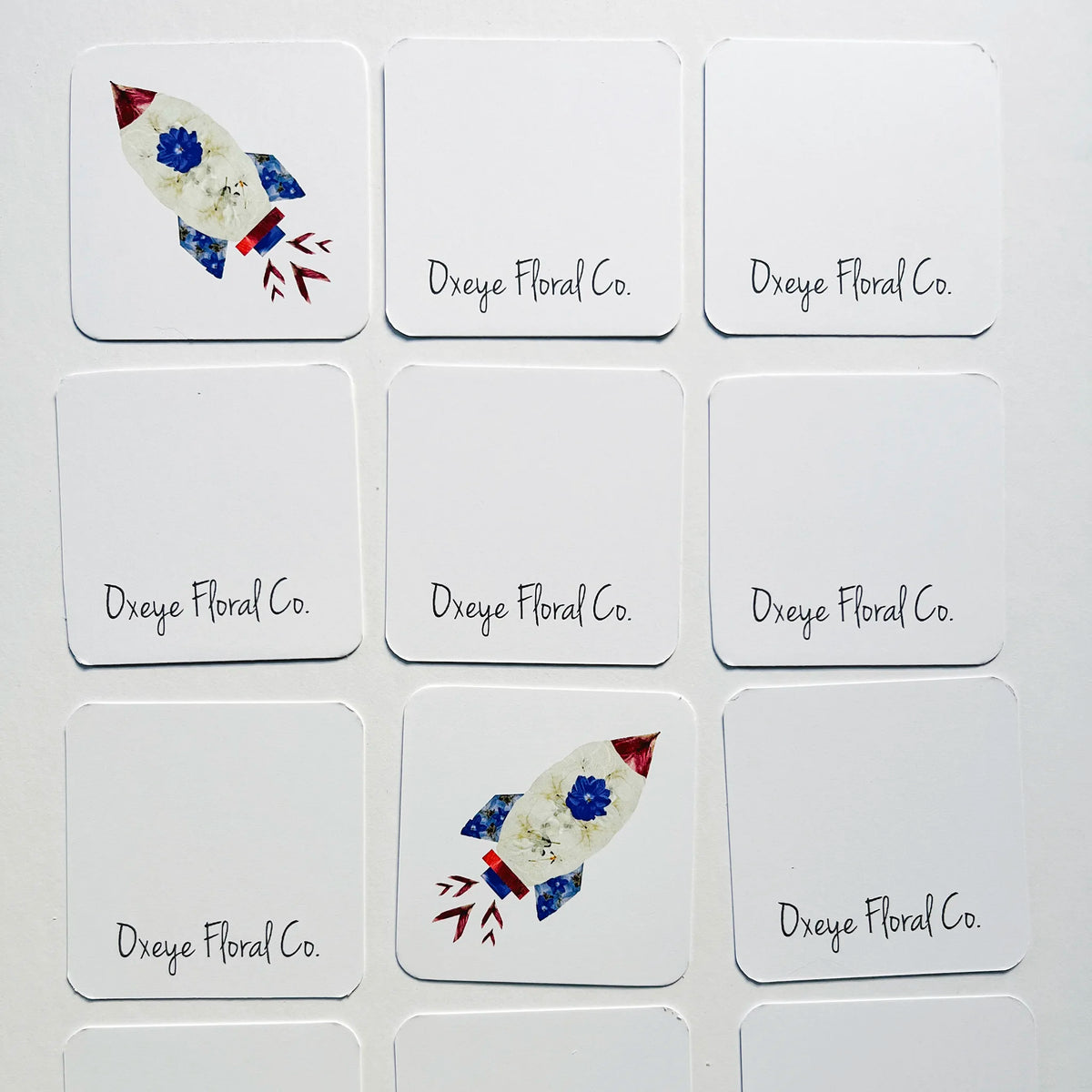 Set of cards with rocket designs and 'Dxeye Floral Co.' text on a white background