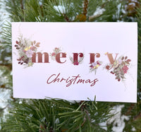 light pink christmas card with the words "merry christmas" and flowers