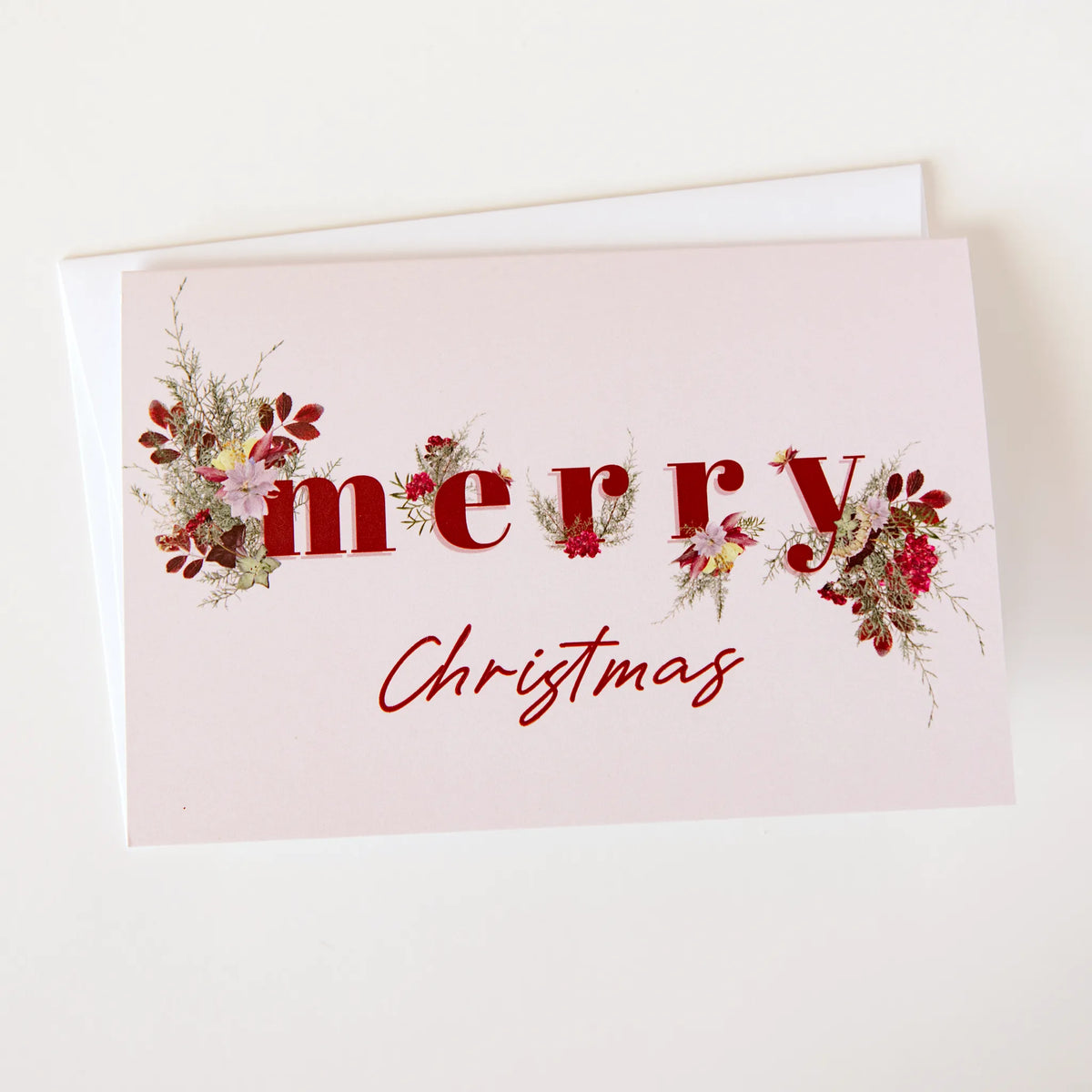 light pink floral christmas card with the words "merry christmas"