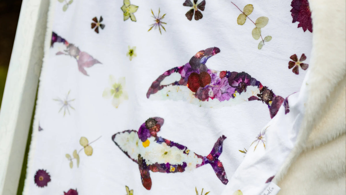 Orca minky baby blanket with killer whales made from purple and white pressed flowers