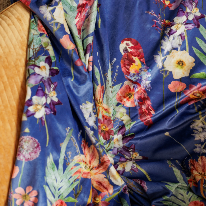 Rich blue throw blanket with pressed flower parrots print