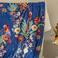 Tropical throw blanket with pressed flowers draped on a chair