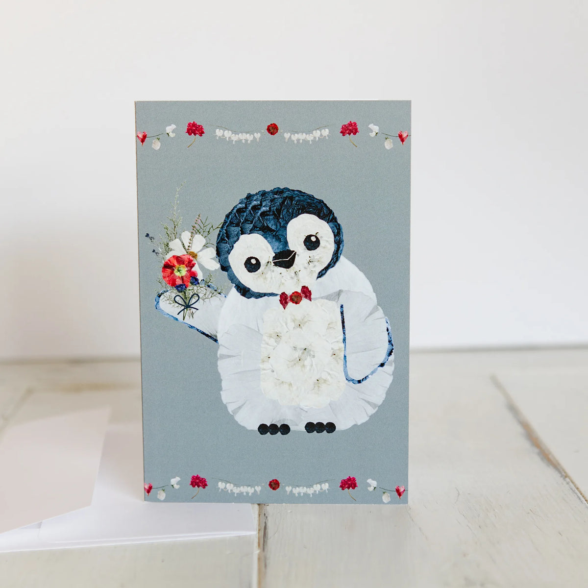 Card with a penguin design on a light gray background