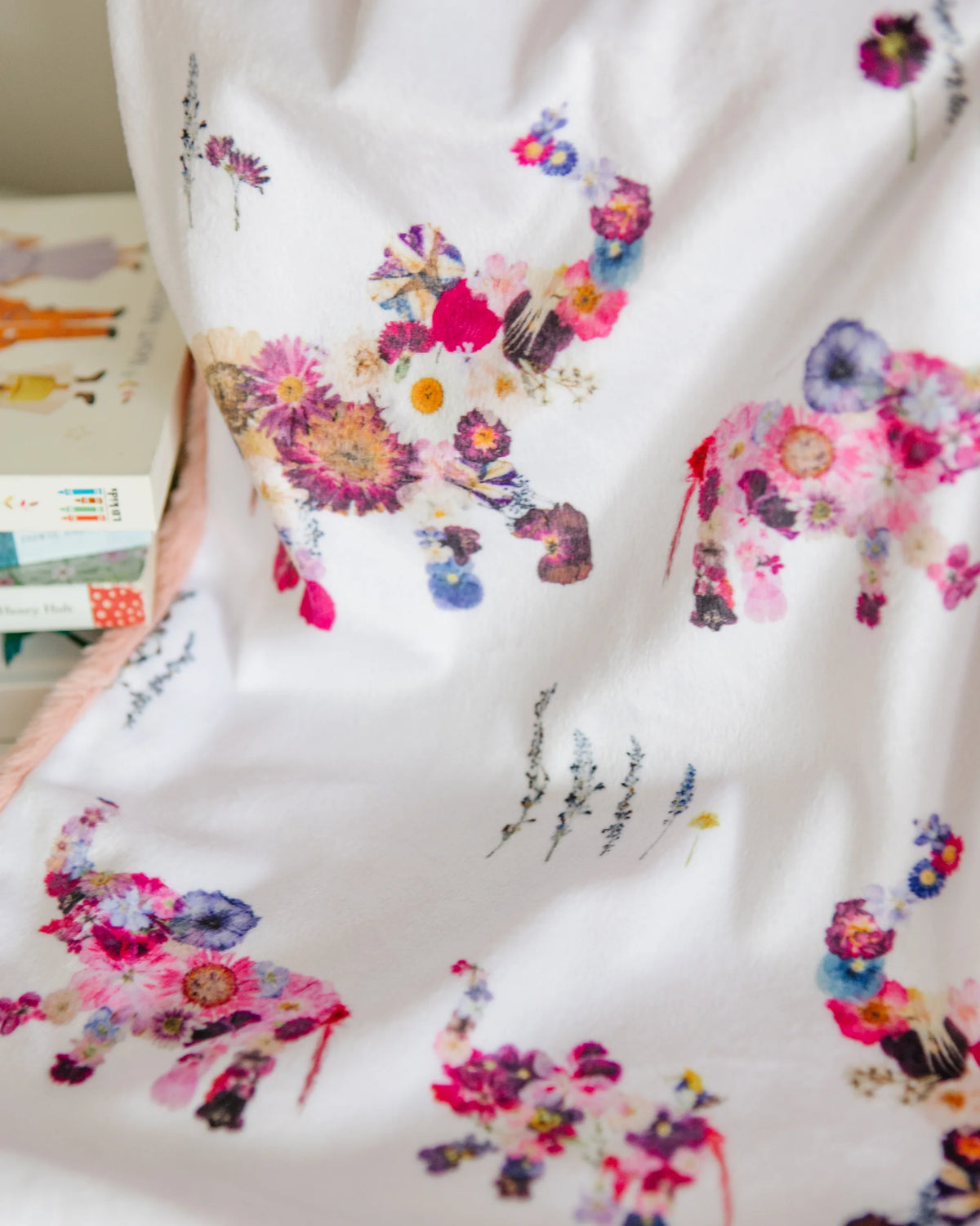Baby blanket with colorful pressed flower elephants on a white background