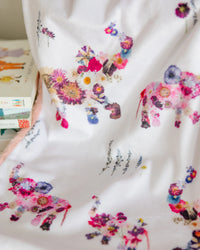 Baby blanket with colorful pressed flower elephants on a white background