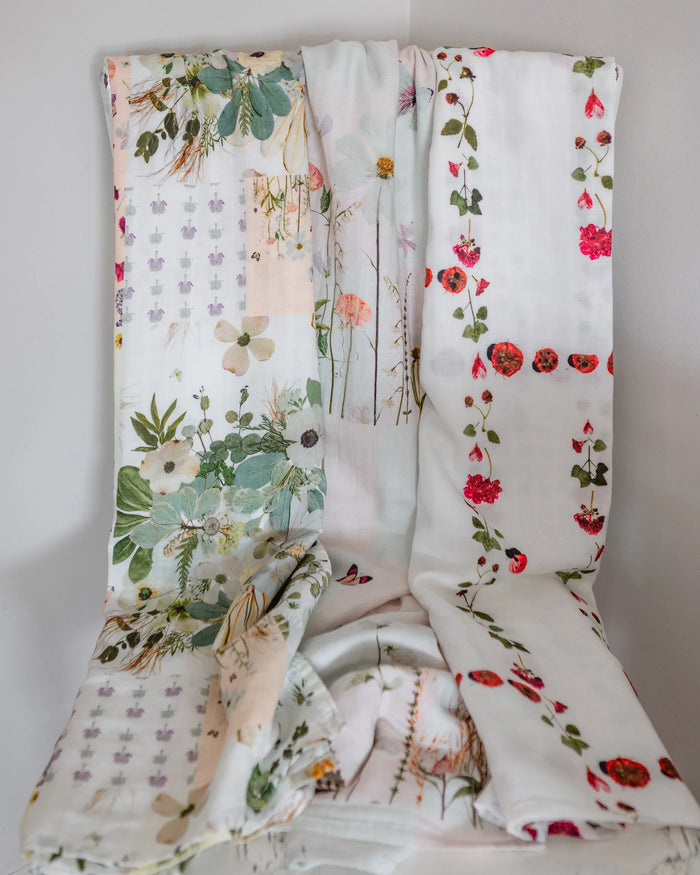 Floral-patterned baby swaddling blankets on a white background