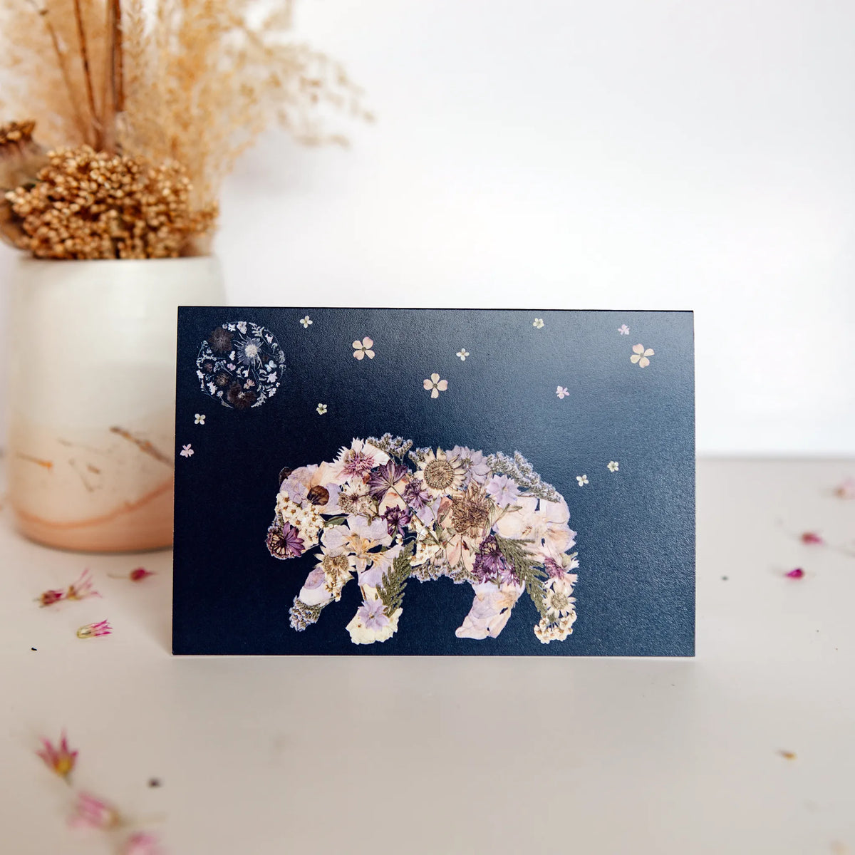 pressed floral bear walking under a flower moon on a christmas card