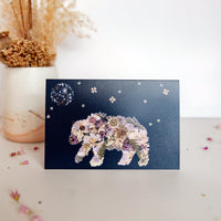 pressed floral bear walking under a flower moon on a christmas card