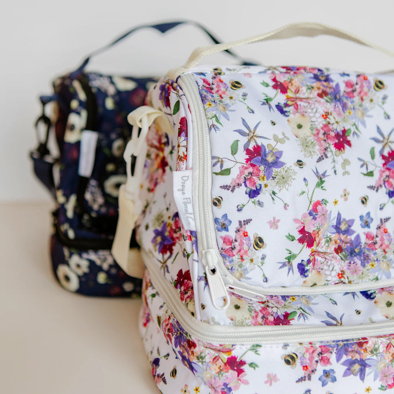 Floral-patterned lunch bags with Oxeye Floral Co logo on a light background