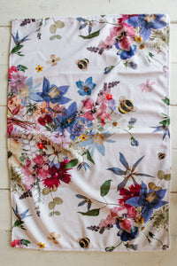 Decorative floral tea towel with pressed flower designs and round bumblebees