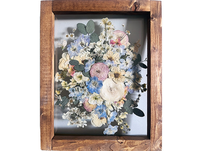 Top-down pressed wedding bouquet in wood frame